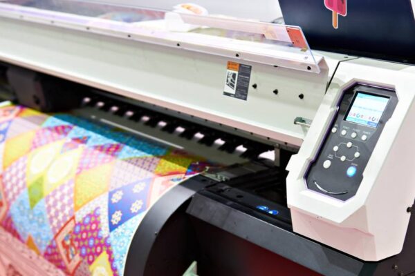 Image of a plotter printer turning out a large and colorful image on a sizable sheet of plotter printer paper.